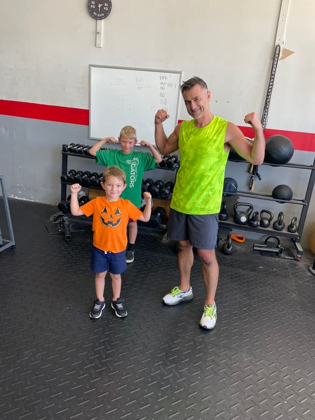 Timothy and boys flexing at the gym