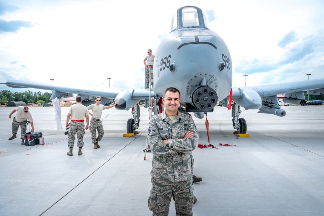 Timothy in Air National Guard uniform in front of an A-10 Warthog