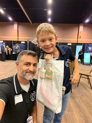Timothy and his son at a tech conference